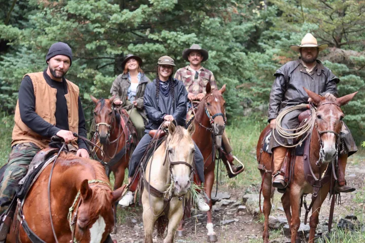 a group of people riding on the back of a horse